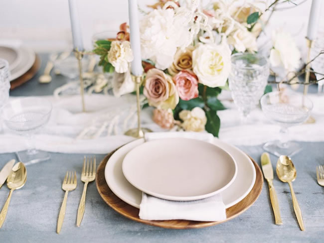 Neutral wedding place setting with gold flatware