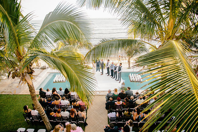 Beach wedding ceremony under palm trees