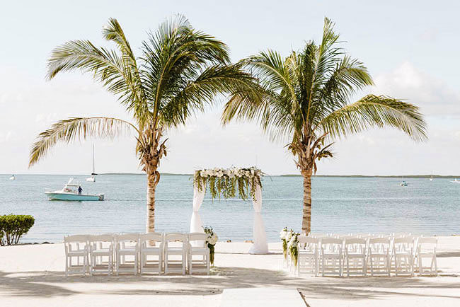 A simple beach wedding ceremony setup overlooking the ocean