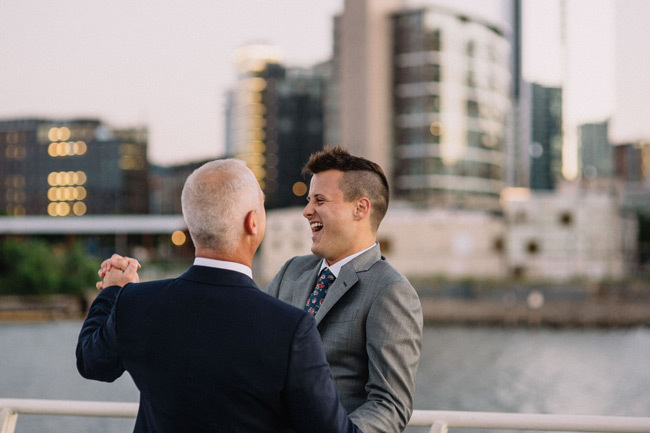 Questions To Ask Your Yacht Wedding Venue | Two grooms first dance on deck