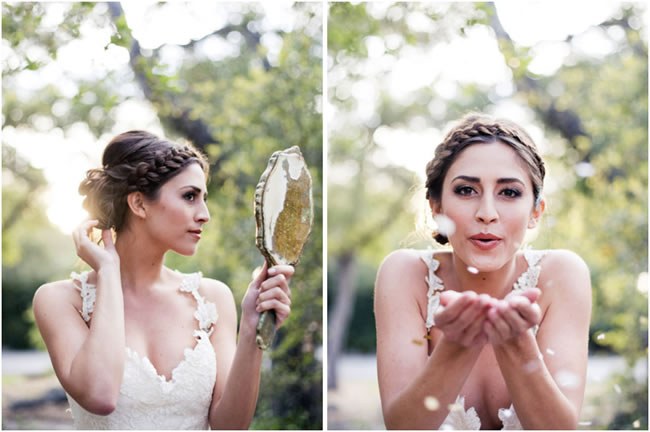 Bride with a braided wedding hairstyle looks at herself in the mirror