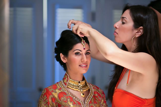 An Indian bride wears a bejeweled bridal maang tika