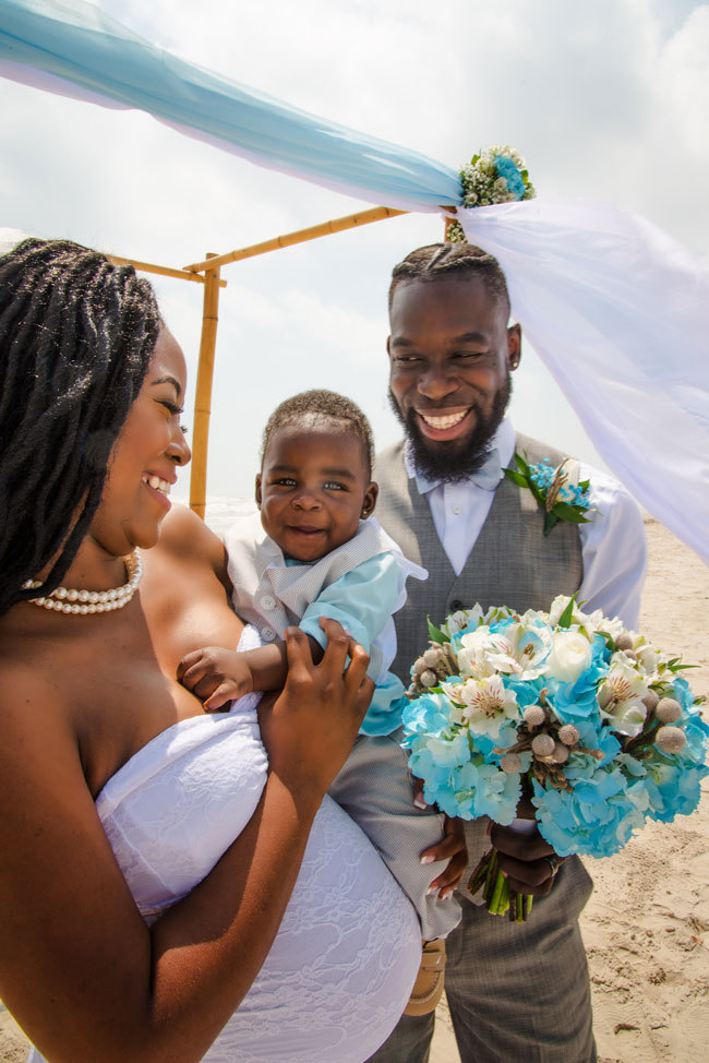 Cute pregnant bride eloping on the beach