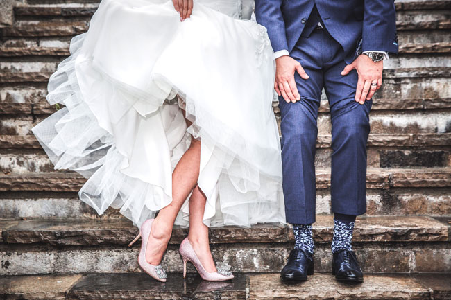 Photo of a bride and groom's shoes on a venue's stairs