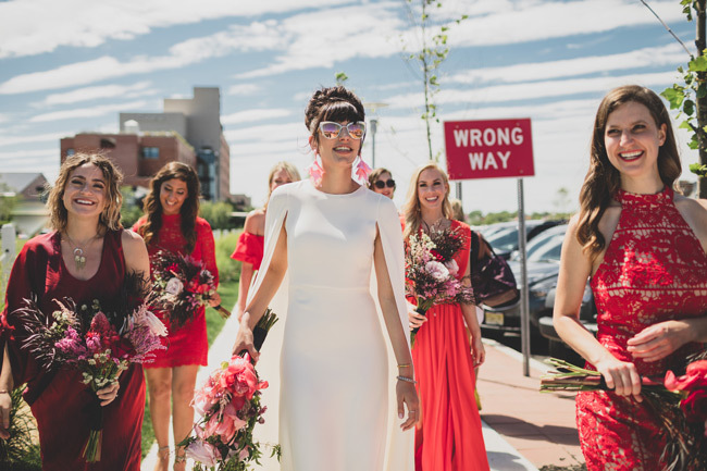 Stylish bride in sunglasses walks with her bridal party | How To Choose a Wedding Photographer