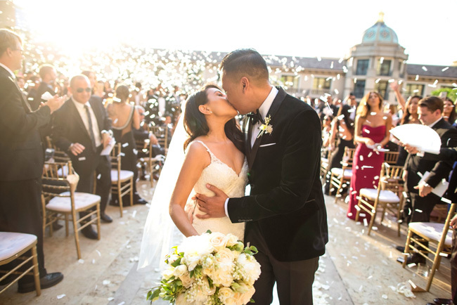 Newlyweds kiss at end of aisle | How To Tip Your Wedding Vendors