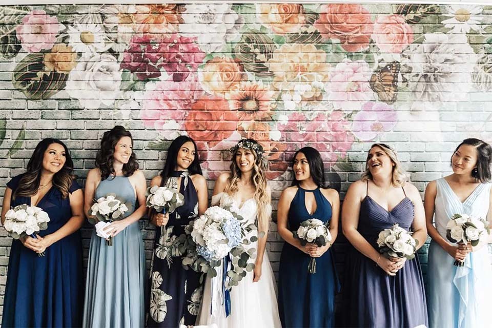 Wedding Budget Planning | Bridesmaids in mismatched dresses at Kimpton Shorebreak Resort