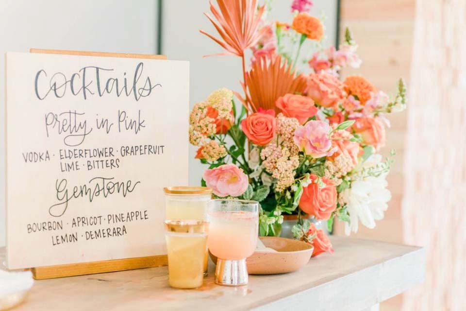 Wedding Budget List | A cute signature cocktails sign with coral floral arrangement