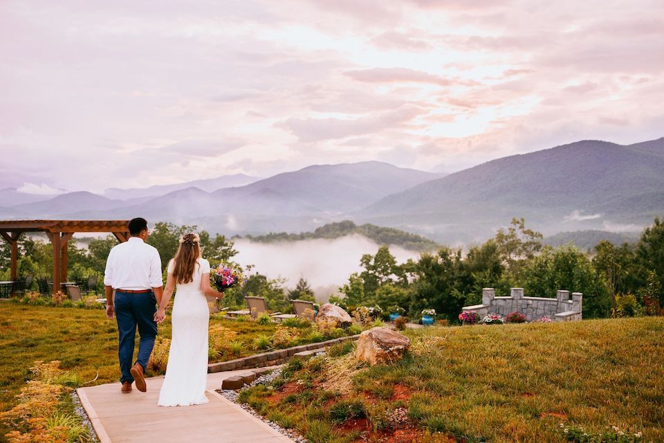 Newlyweds overlook beautiful mountain scenery | Cheap Wedding Ideas